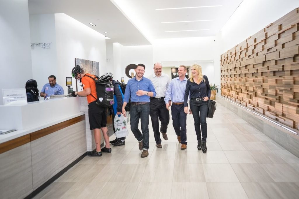 a group of people walking in a hallway