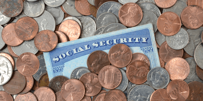 a pile of coins and a social security card