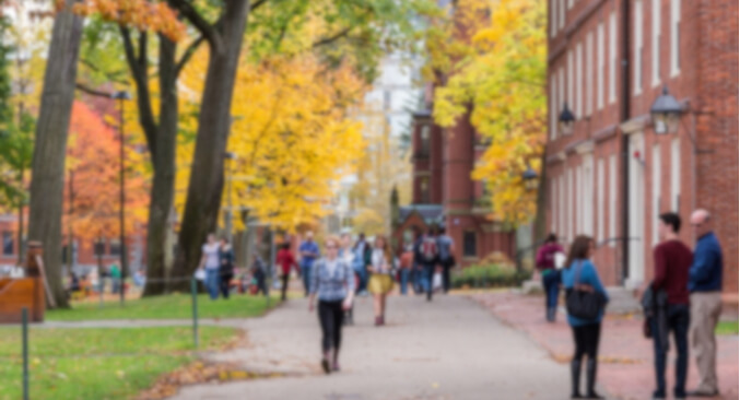 a group of people walking down a sidewalk