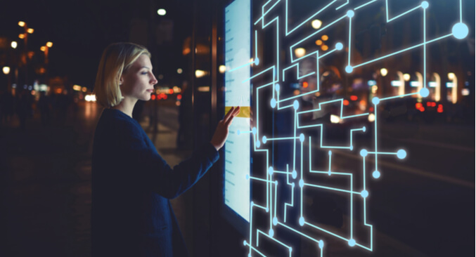 person standing in front of large monitor