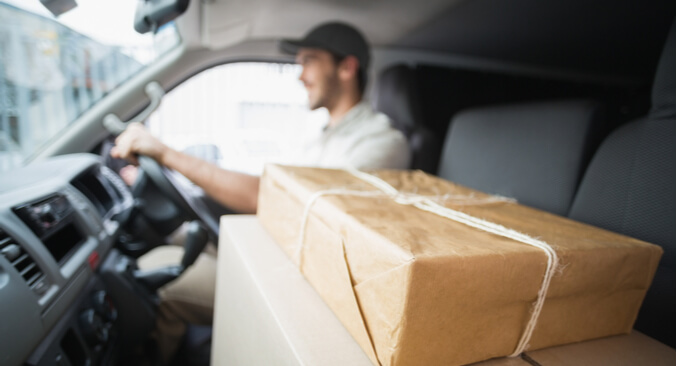 a person driving a car next to packages