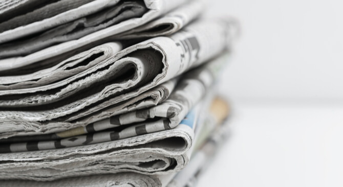 a pile of folded newspapers