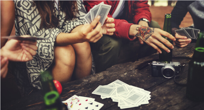 a group of people playing cards