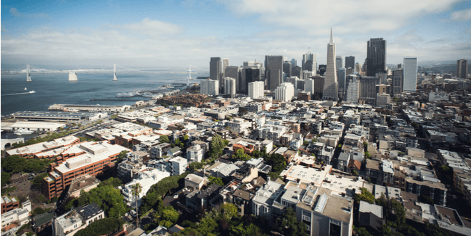 a city with a body of water in the background