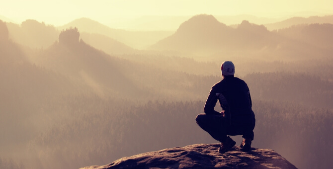 a man sitting on a rock