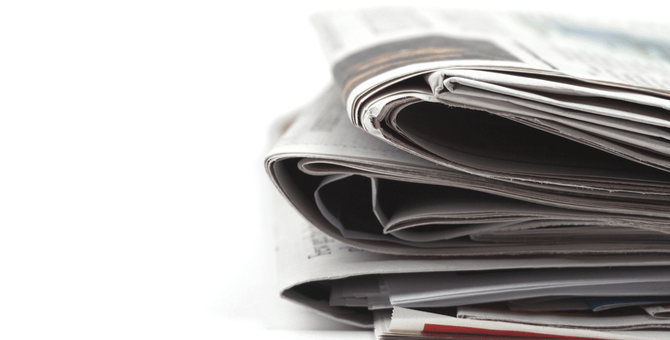 stack of folded newspapers