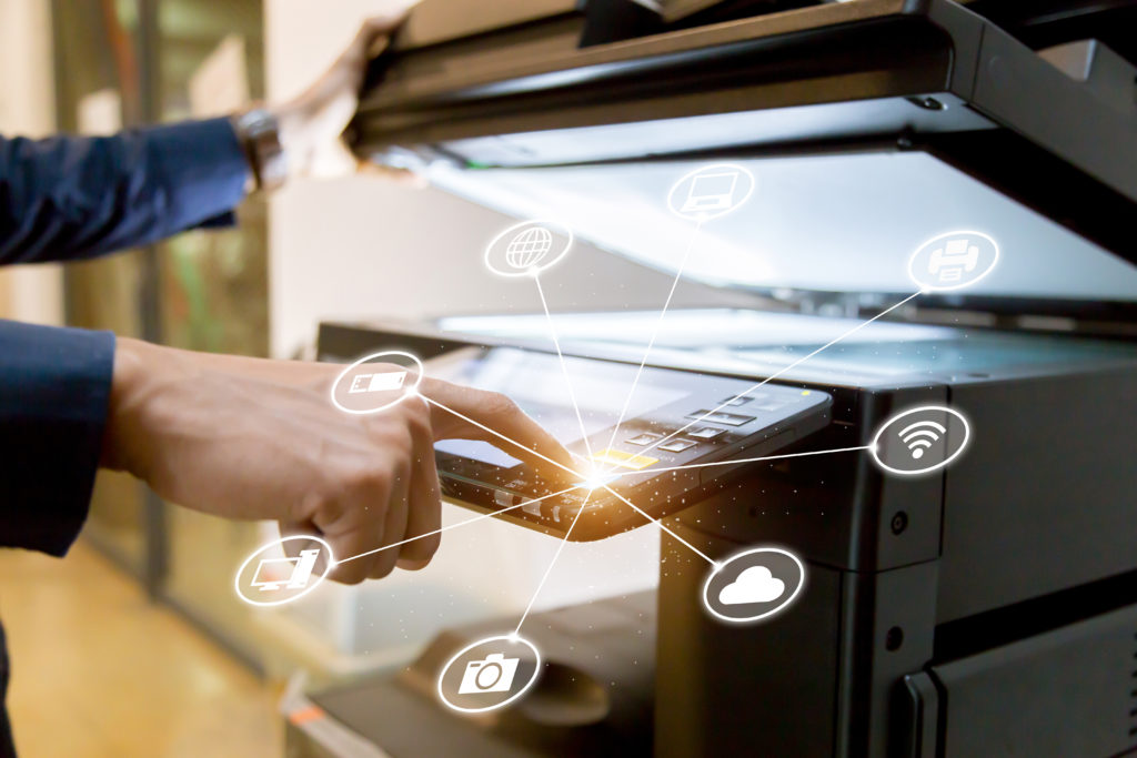 person using a multi-function copier