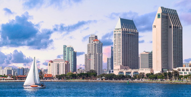 a sailboat in front of a city skyline