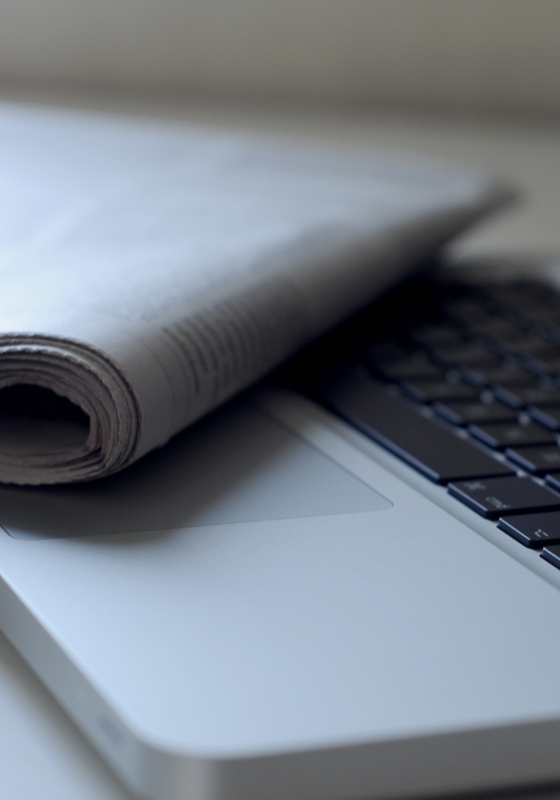 laptop with a newspaper on it