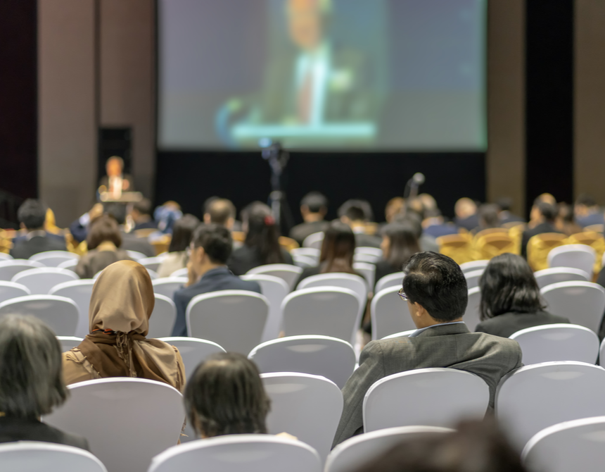 a group of people sitting in a lecture hall