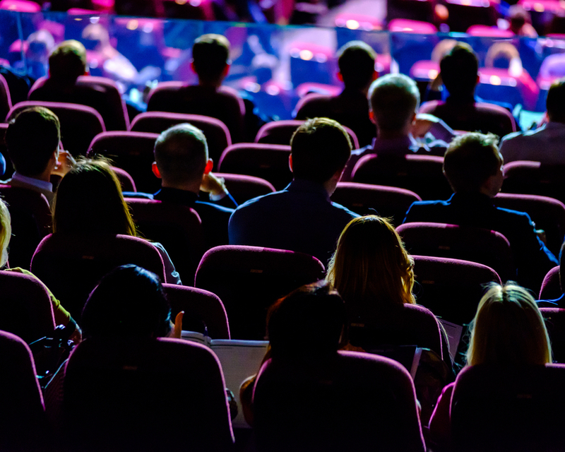 a group of people in a lecture hall