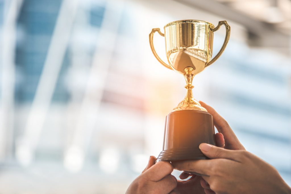 a person holding a trophy