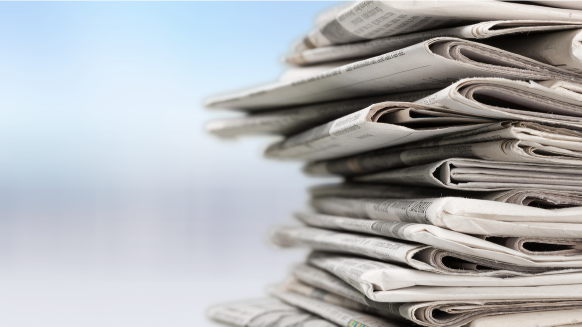 a pile of folded newspapers